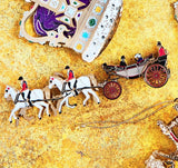Side Shot of the 24-carat gold-finished Ascot Landau Horse-Drawn Carriage Christmas Ornament, hand-crafted and designed in London. This luxury keepsake features sculpted horses and the royal family seated in the historic Ascot Landau carriage, celebrating royal pageantry and British craftsmanship.