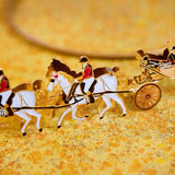 Close up Shot of the 24-carat gold-finished Ascot Landau Horse-Drawn Carriage Christmas Ornament, hand-crafted and designed in London. This luxury keepsake features sculpted horses and the royal family seated in the historic Ascot Landau carriage, celebrating royal pageantry and British craftsmanship.